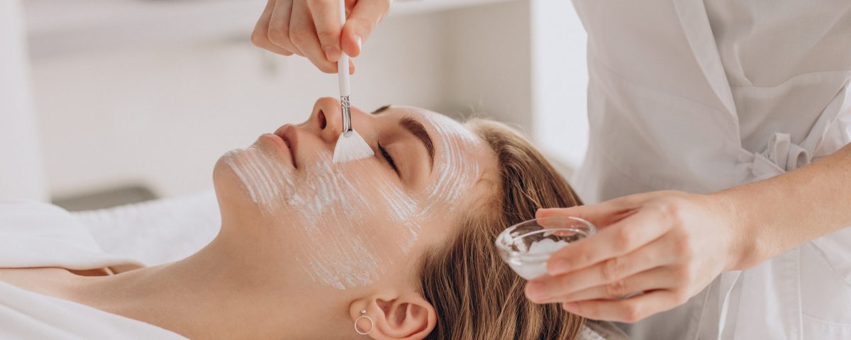 Cosmetologist Doing Face Treatment Applying Face Mask
