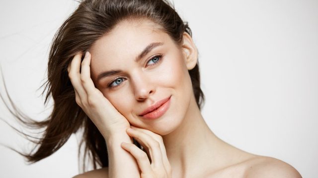 Beautiful Naked Young Woman With Perfect Clean Skin Smiling Touching Hair White Wall Facial Treatment