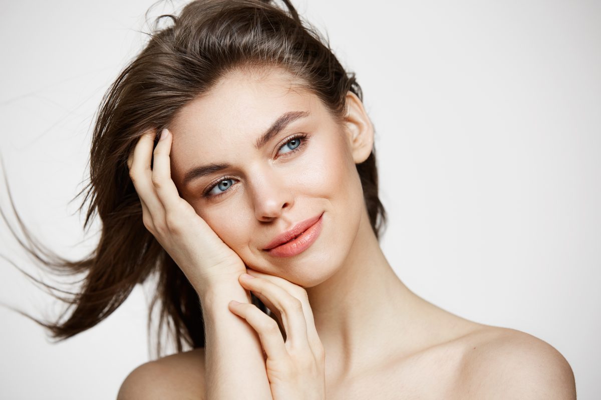Beautiful Naked Young Woman With Perfect Clean Skin Smiling Touching Hair White Wall Facial Treatment